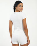 Ghost mannequin back view of white ribbed t-shirt top displaying clean seam finish and fitted silhouette.