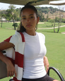 Plus size model front view wearing white sculpting ribbed t-shirt top styled with dark bottoms.
