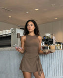 Plus size model wearing brown active dress with wrap skirt detail, front view demonstrating inclusive sculpting fit and flattering wrap silhouette.