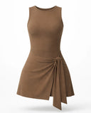 Women's brown active dress with wrap skirt detail displayed on ghost mannequin, back view highlighting sleeveless design and clean finish.