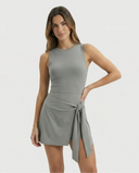 Women's grey active set with sculpting sleeveless top and wrap-tie skirt displayed on ghost mannequin, front view.