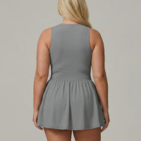 Back studio view of model wearing SEEN Essential grey padel sport dress showing clean seamless back and flared skirt.