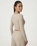 SEEN Essential women's brown yoga set featuring wrap top and high-waist wide leg pants shown on ghost mannequin, back view.