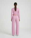 SEEN Essential women's pink yoga set with long-sleeve wrap crop top and wide leg pants displayed on ghost mannequin, front view.