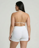 Model wearing a white seamless sculpt gym set with high waist shorts and a supportive sports bra paired with athletic sneakers.