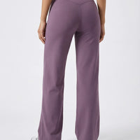 Model wearing mauve high waist crossover wide leg leggings, back view cropped to show V-stitch waistband and wide leg silhouette.