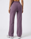 Model wearing mauve high waist crossover wide leg leggings, back view cropped to show V-stitch waistband and wide leg silhouette.