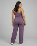Curvy model wearing mauve high waist crossover wide leg leggings with matching tank top, back view