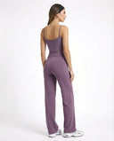 Model wearing mauve high waist crossover wide leg leggings with matching tank top, back view showing V-stitch detail.