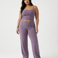 Curvy model wearing mauve high waist crossover wide leg leggings with matching tank top, front view showing V-panel waistband.