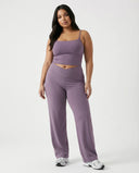 Curvy model wearing mauve high waist crossover wide leg leggings with matching tank top, front view showing V-panel waistband.