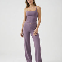 Model wearing mauve high waist crossover wide leg leggings with matching tank top, front view showing sculpting crossover waistband.