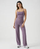 Model wearing mauve high waist crossover wide leg leggings with matching tank top, front view showing sculpting crossover waistband.
